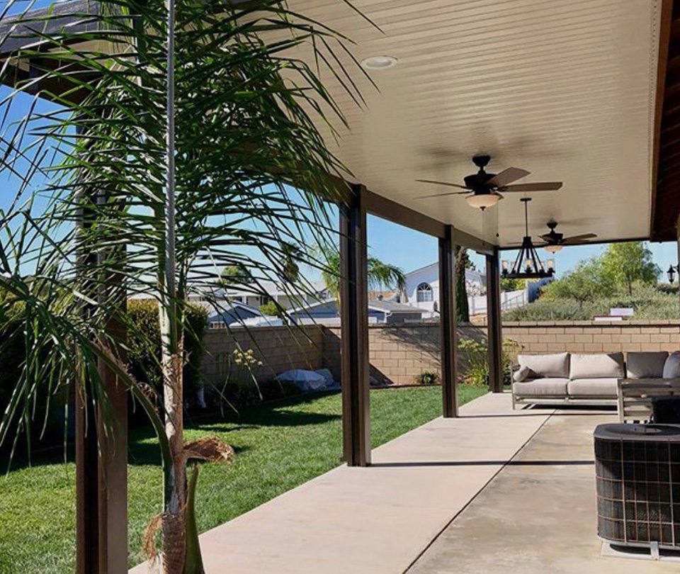 Custom patio cover lounge area with installed ceiling fans