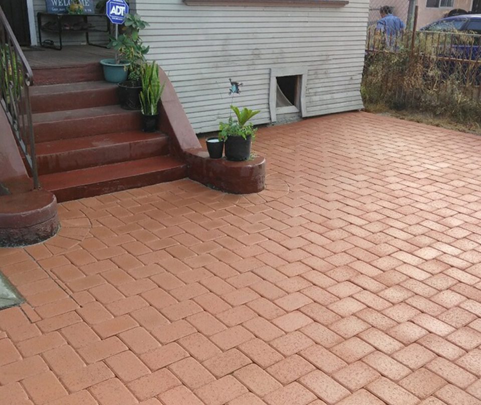 Brown interlocking custom pavers installed in backyard