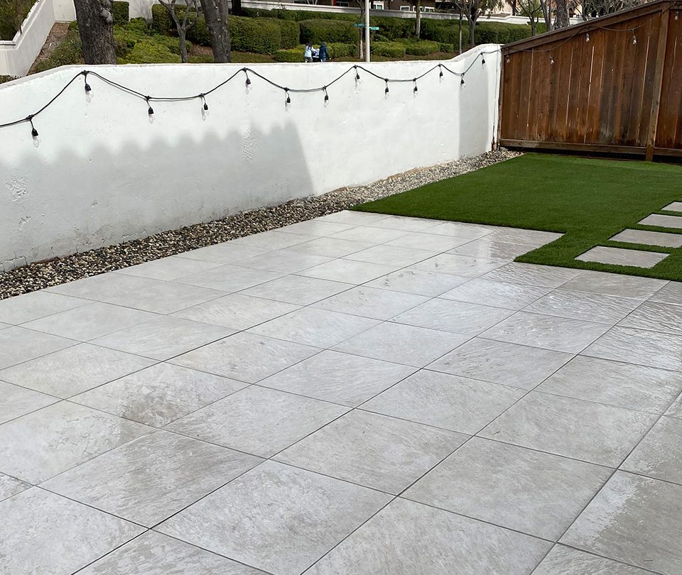 Market Lights with custom gray stone pavers and turf