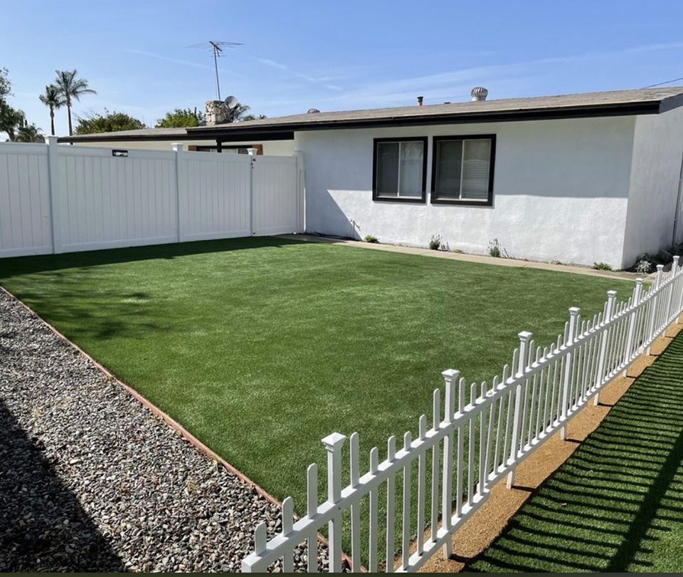 White house with pet friendly artificial turf