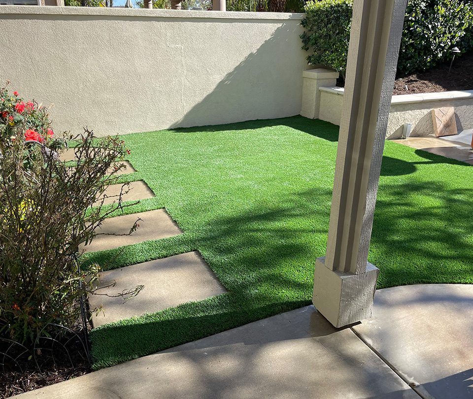 Pet friendly artifical turf with Brown pavers installed around