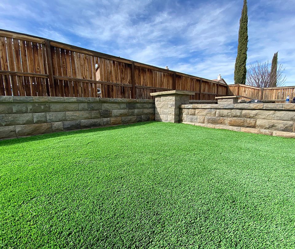 Closeup of synthetic turf and paver walls